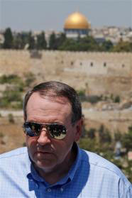 Back-dropped by the golden shrine of the Dome of the Rock in Jerusalem's Old City, former Arkansas governor and US presidential hopeful Mike Huckabee is seen during his tour in the east Jerusalem neighborhood of Ras al Amud, Monday, Aug. 17, 2009.